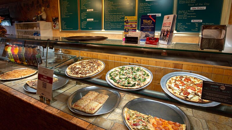 Pizza counter with many pizza pies