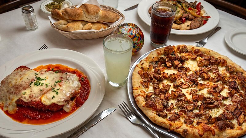 Four plated entrees with drinks